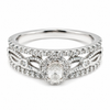 9ct white gold oval cut diamond halo engagement ring with intricate split shank and pave diamond accents by Cassim and Co