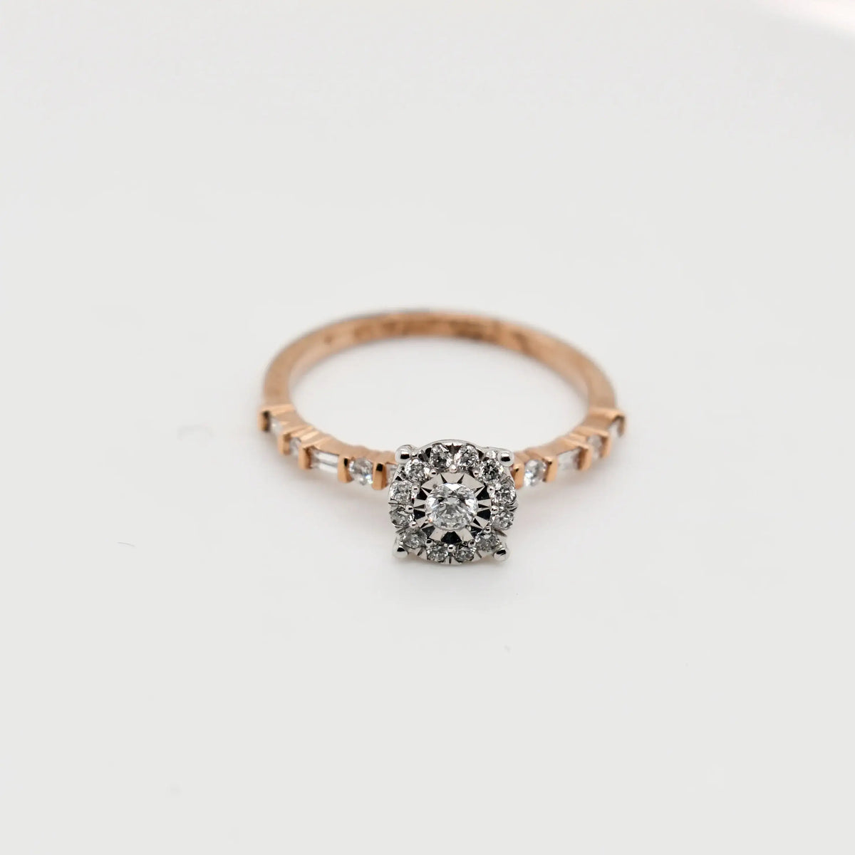9ct rose gold round cluster diamond engagement ring with halo setting and baguette diamond shoulders - Cassim & Co. Johannesburg