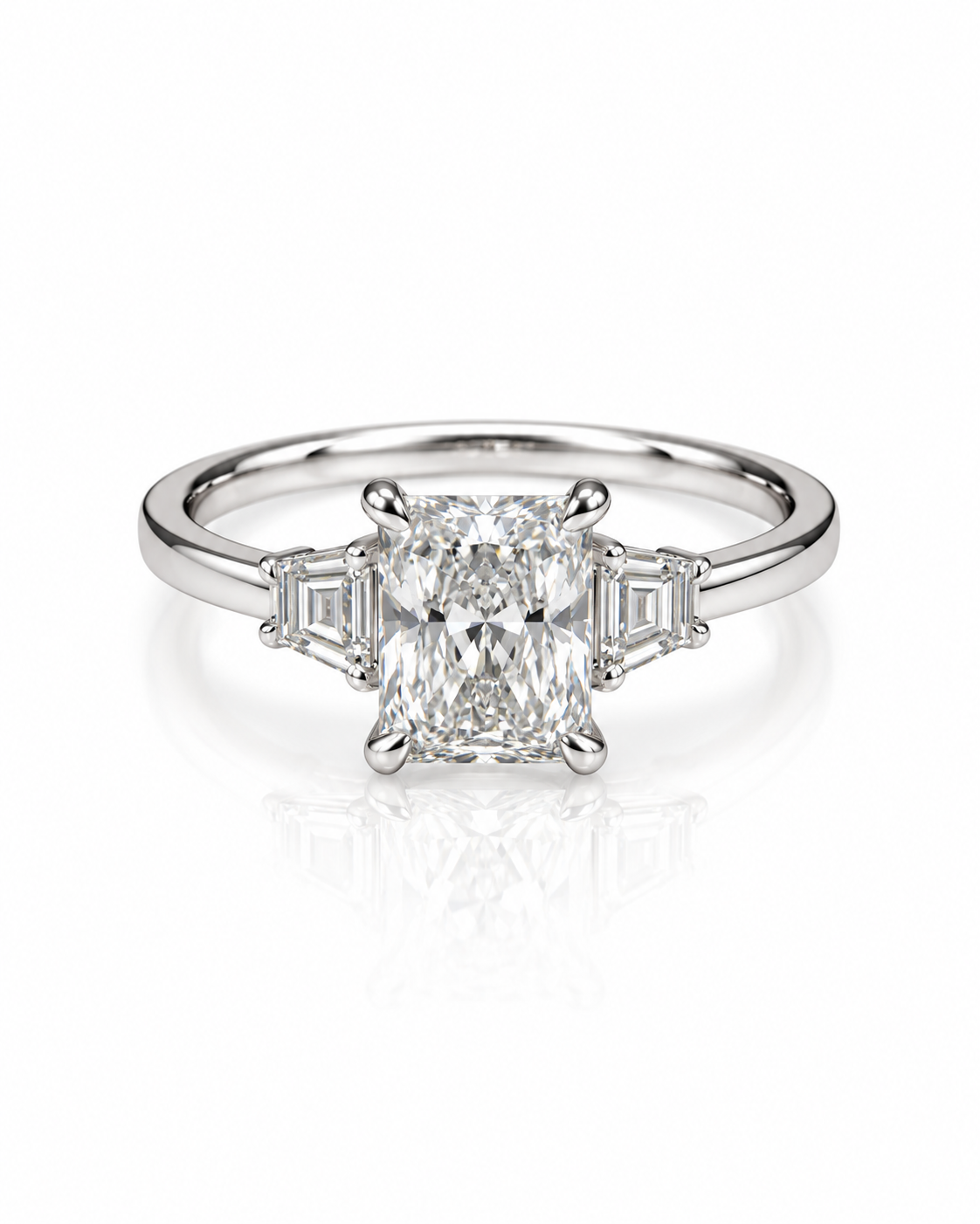 9ct white gold three-stone engagement ring with 1.5ct elongated radiant cut lab grown diamond and emerald cut side stones from Cassims & Co.