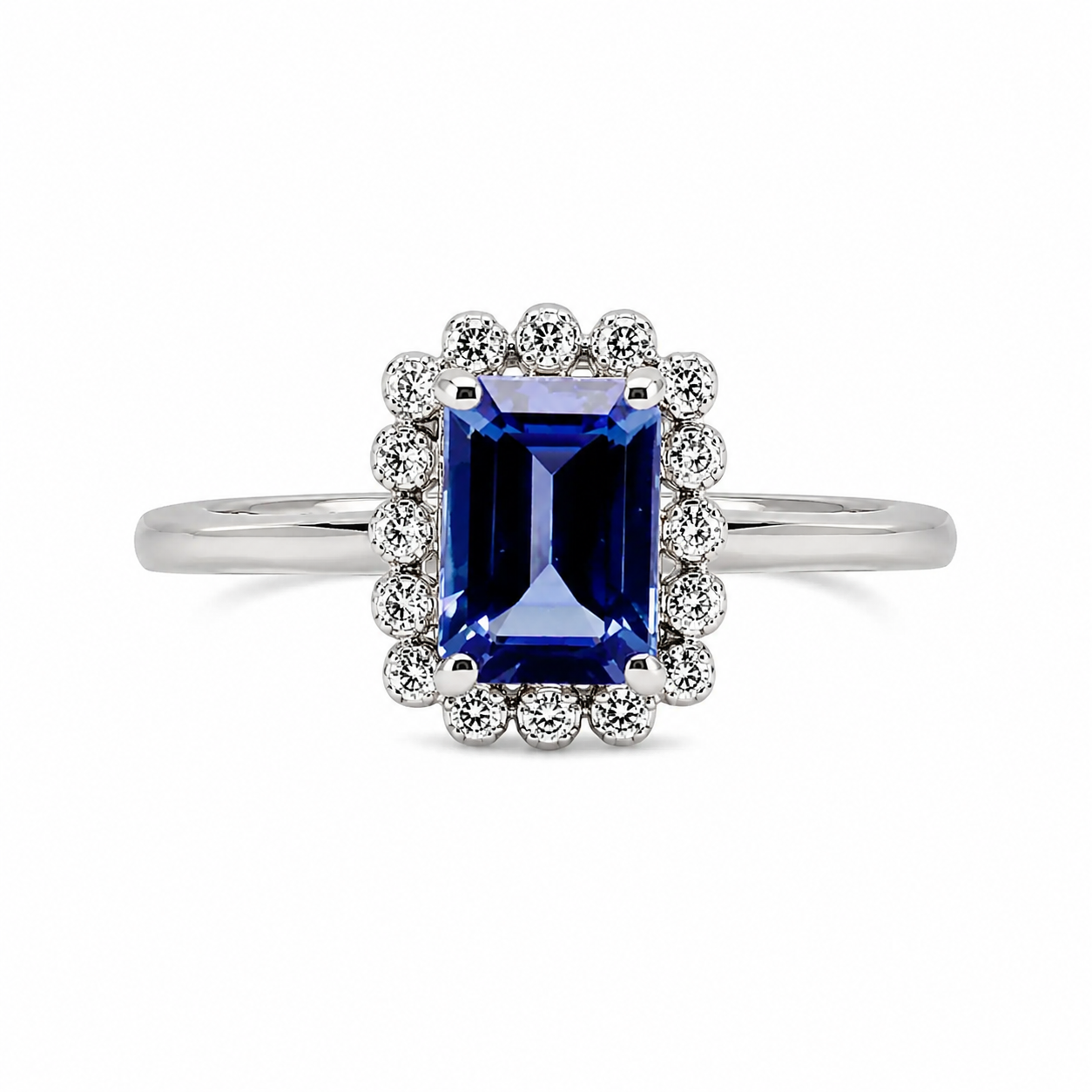 9ct white gold emerald cut tanzanite diamond halo engagement ring on white background