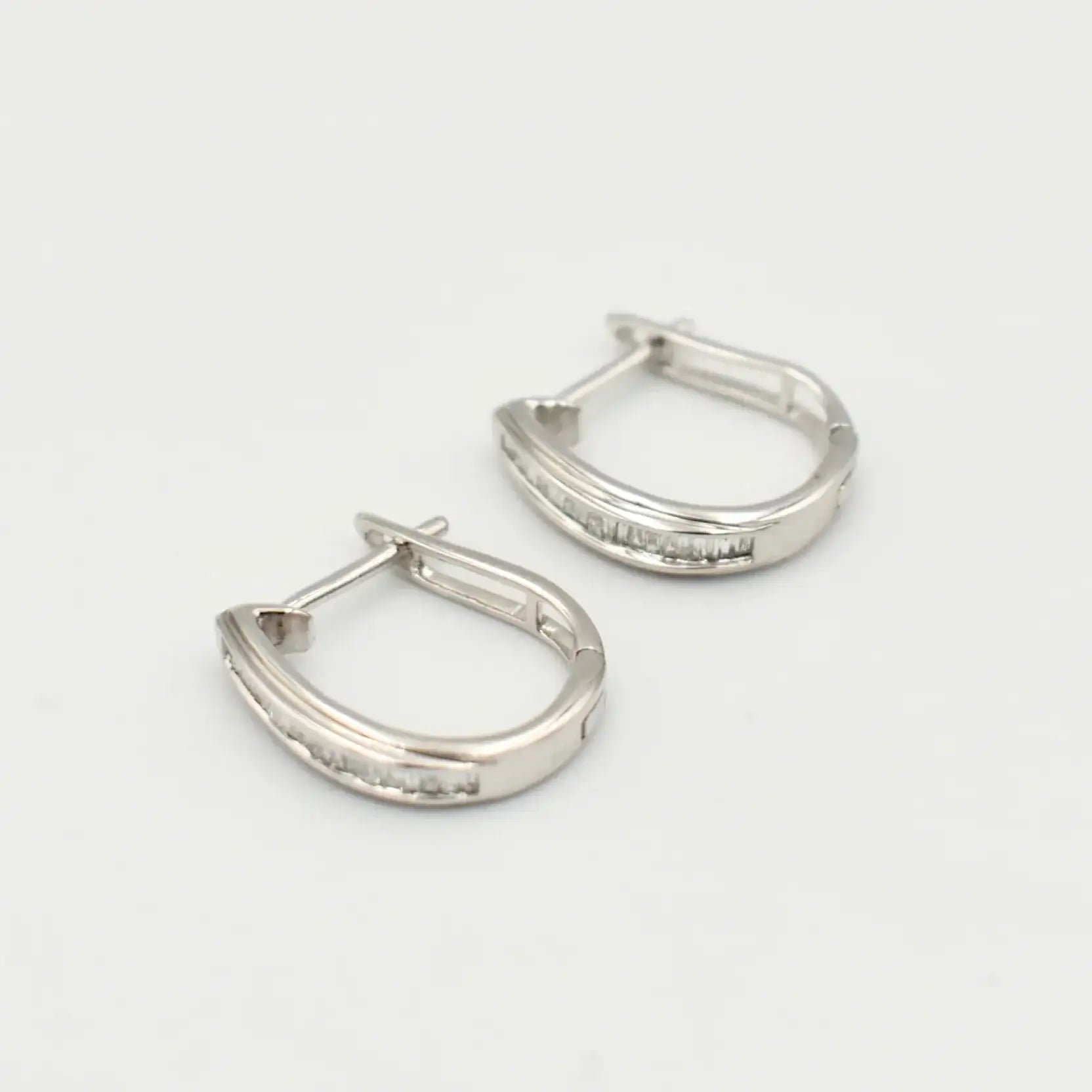 9ct white gold hoop earrings with baguette diamond channel setting, hinged clasp closure, luxury diamond jewellery by Cassim & Co