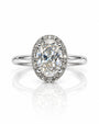 9ct white gold oval halo engagement ring with pavé diamonds and four claws on a slim polished band