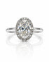 9ct white gold oval halo engagement ring with pavé diamonds and four claws on a slim polished band