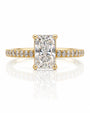 Yellow gold solitaire ring with elongated cushion diamond, four claws and pavé-set shoulders