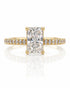 Yellow gold solitaire ring with elongated cushion diamond, four claws and pavé-set shoulders