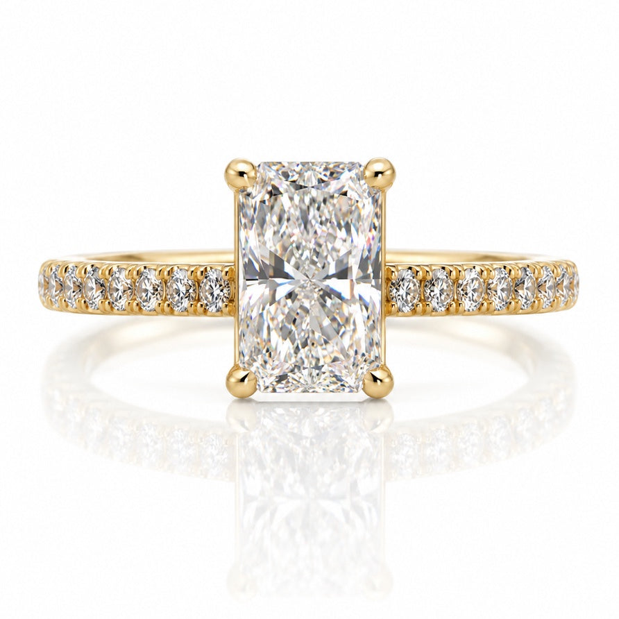 Yellow gold solitaire ring with elongated cushion diamond, four claws and pavé-set shoulders