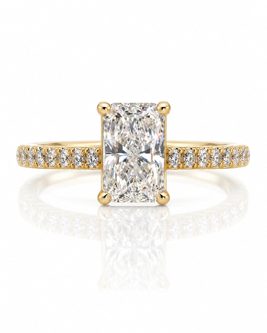 Yellow gold solitaire ring with elongated cushion diamond, four claws and pavé-set shoulders