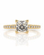 Yellow gold solitaire ring with princess-cut diamond in four-claw setting and pavé shoulders