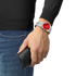 Tissot PRX 40mm worn on the wrist with red dial and steel bracelet