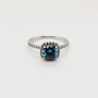 1ct blue cushion cut moissanite halo engagement ring in 9ct white gold with pavé band by Cassim & Co