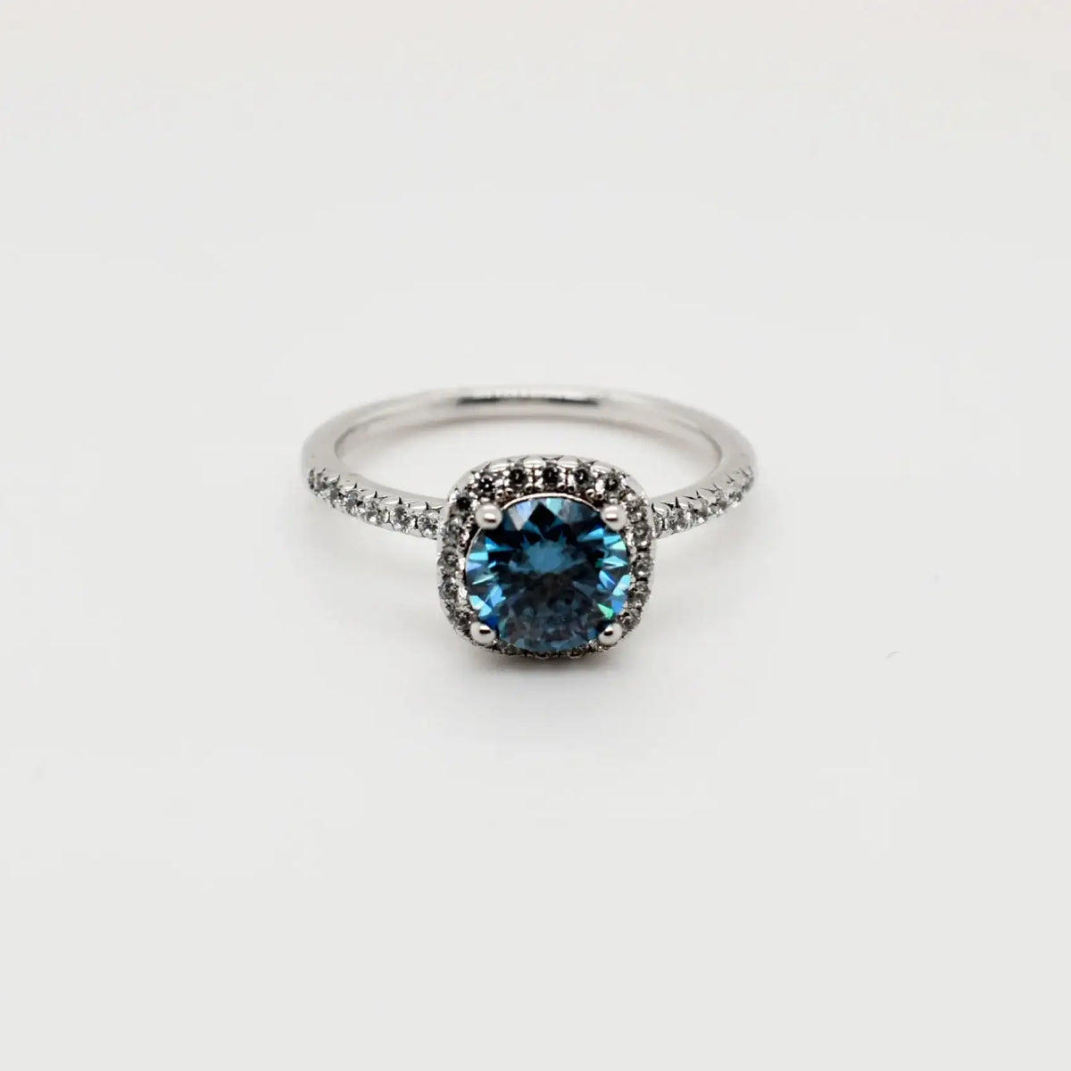 1ct blue cushion cut moissanite halo engagement ring in 9ct white gold with pavé band by Cassim & Co