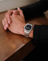 Black dial with applied indices and date window at three o'clock