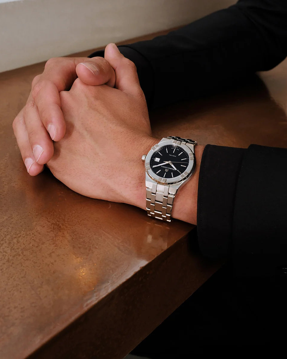 Black dial with applied indices and date window at three o'clock