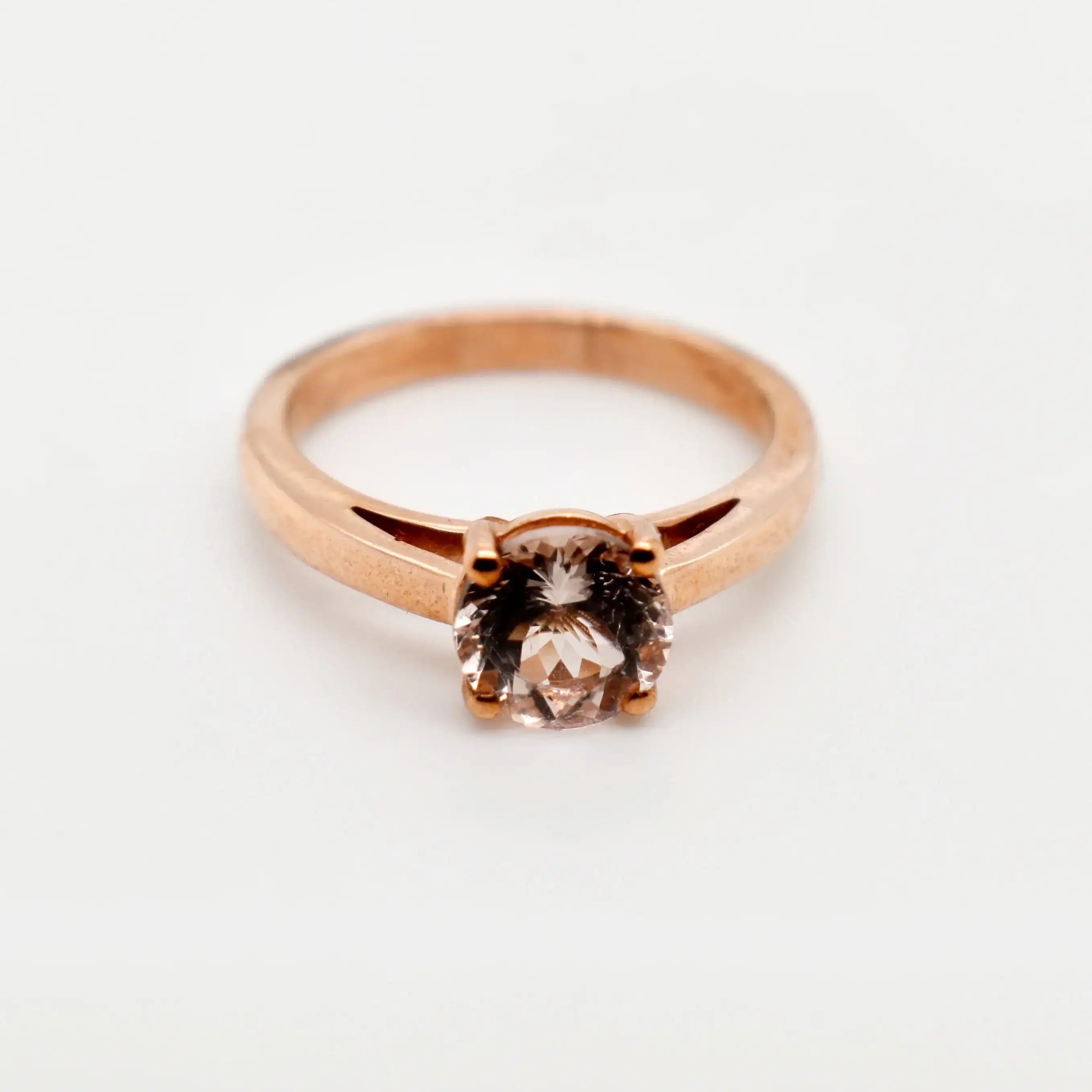 9ct rose gold morganite engagement ring with round brilliant cut stone in four claw solitaire setting on white background