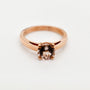 9ct rose gold morganite engagement ring with round brilliant cut stone in four claw solitaire setting on white background