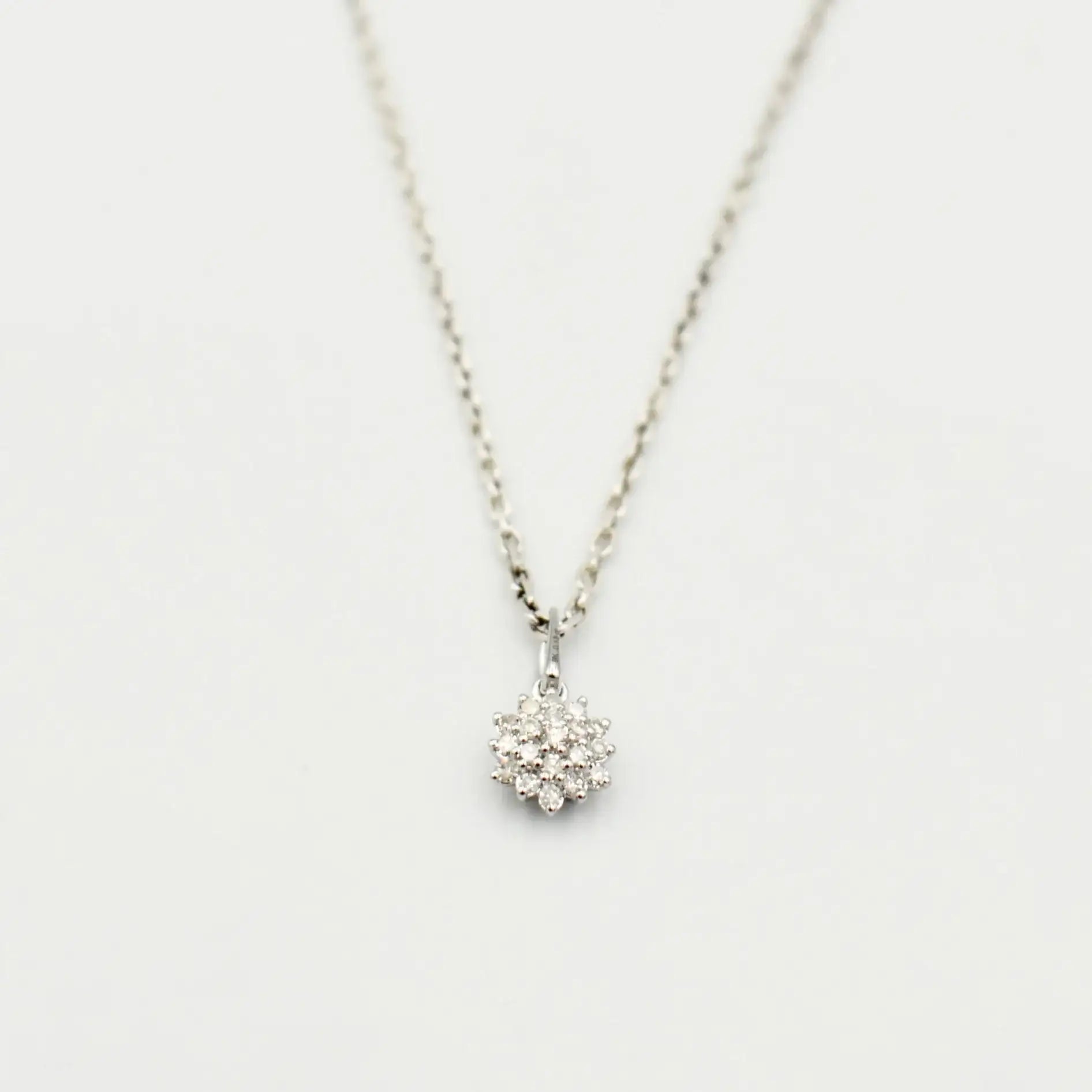 9ct white gold diamond cluster necklace featuring 0.12 carat natural diamonds in floral setting on fine link chain