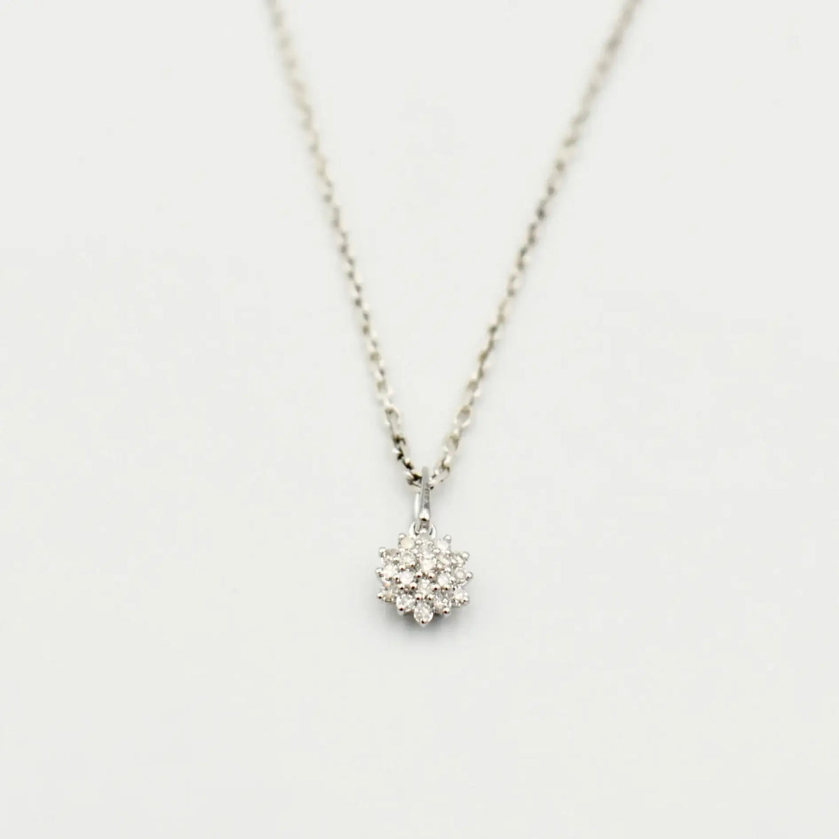 9ct white gold diamond cluster necklace featuring 0.12 carat natural diamonds in floral setting on fine link chain