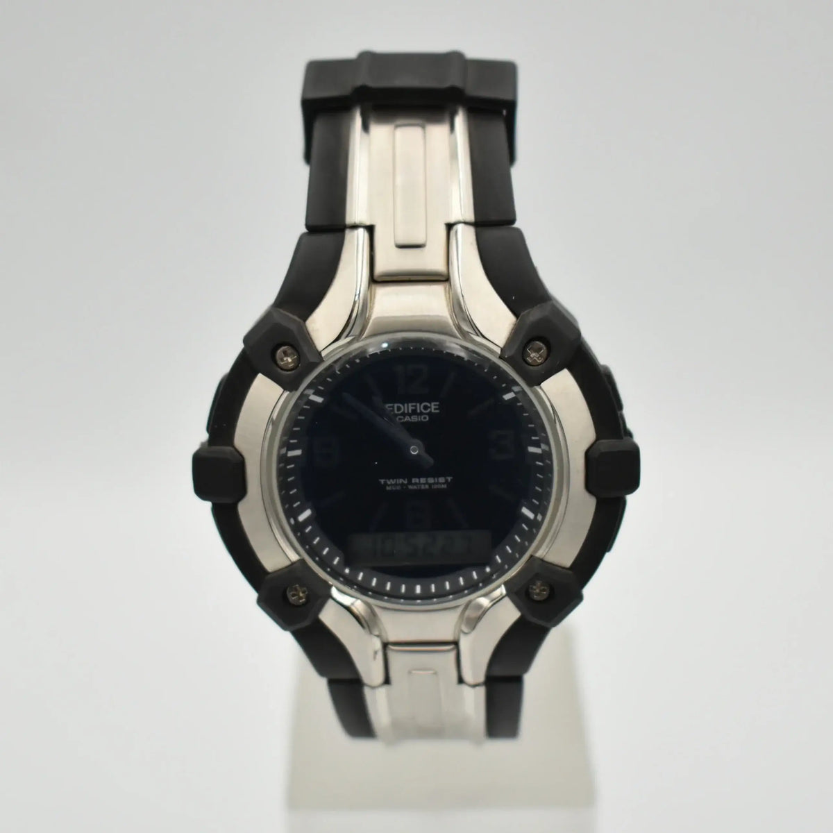 Casio Edifice AMW-200 ana-digi quartz watch with black dial, stainless steel case, and black resin strap on white display stand