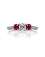 9ct white gold trilogy engagement ring with round diamond centre, ruby side stones and pavé diamond shoulders