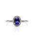 9ct white gold engagement ring with oval tanzanite centre stone and diamond halo