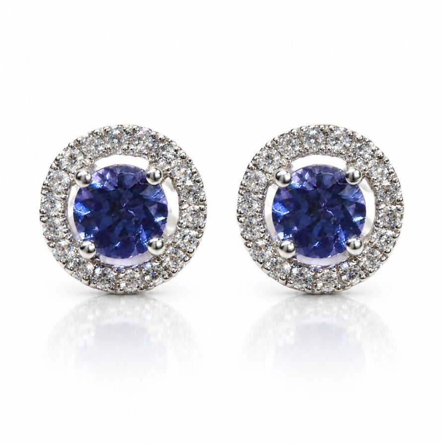 Pair of 14ct white gold stud earrings with round tanzanite centres and diamond halos