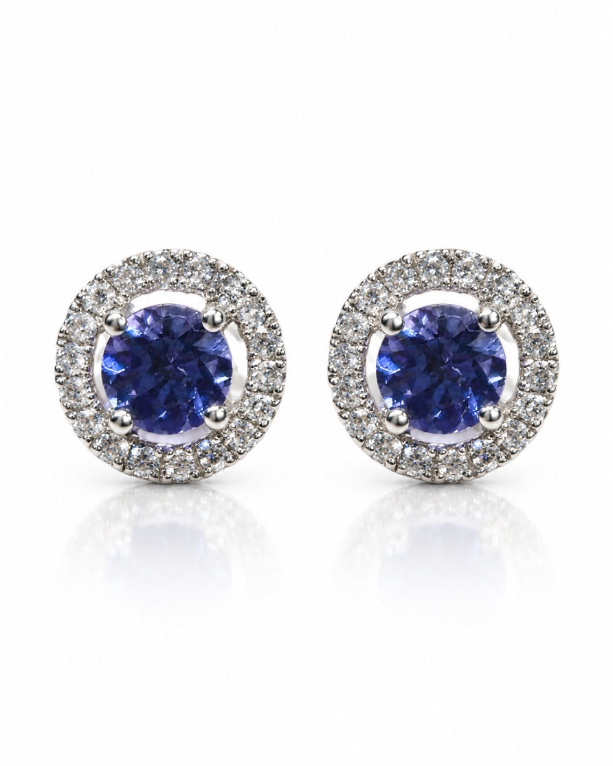 Pair of 14ct white gold stud earrings with round tanzanite centres and diamond halos