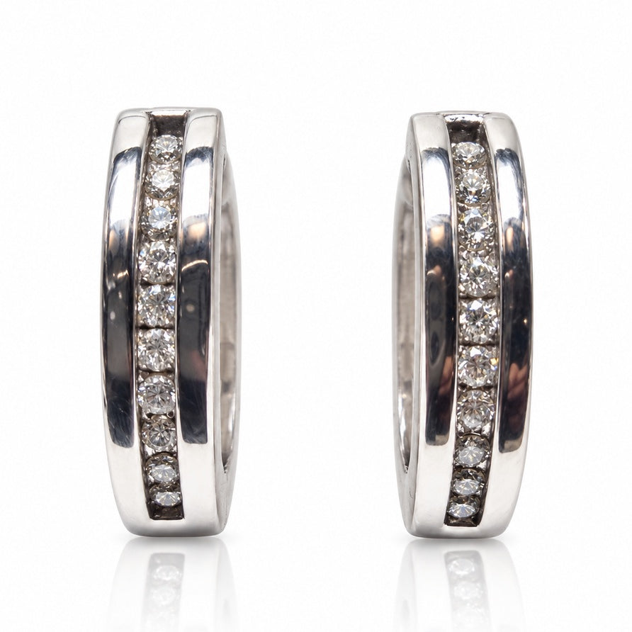 Pair of 9ct white gold huggie earrings with channel-set round diamonds and polished rails