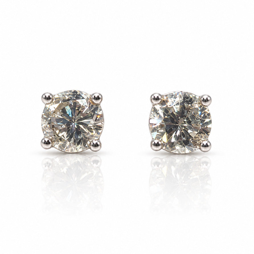 Pair of 9ct white gold four-claw stud earrings with round brilliant diamonds