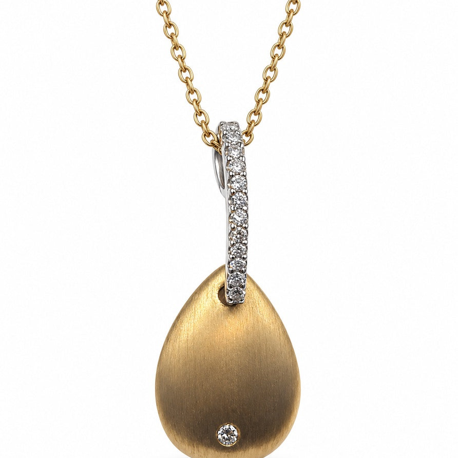Brushed yellow gold teardrop pendant with bezel-set round diamond and pavé white gold bail on cable chain
