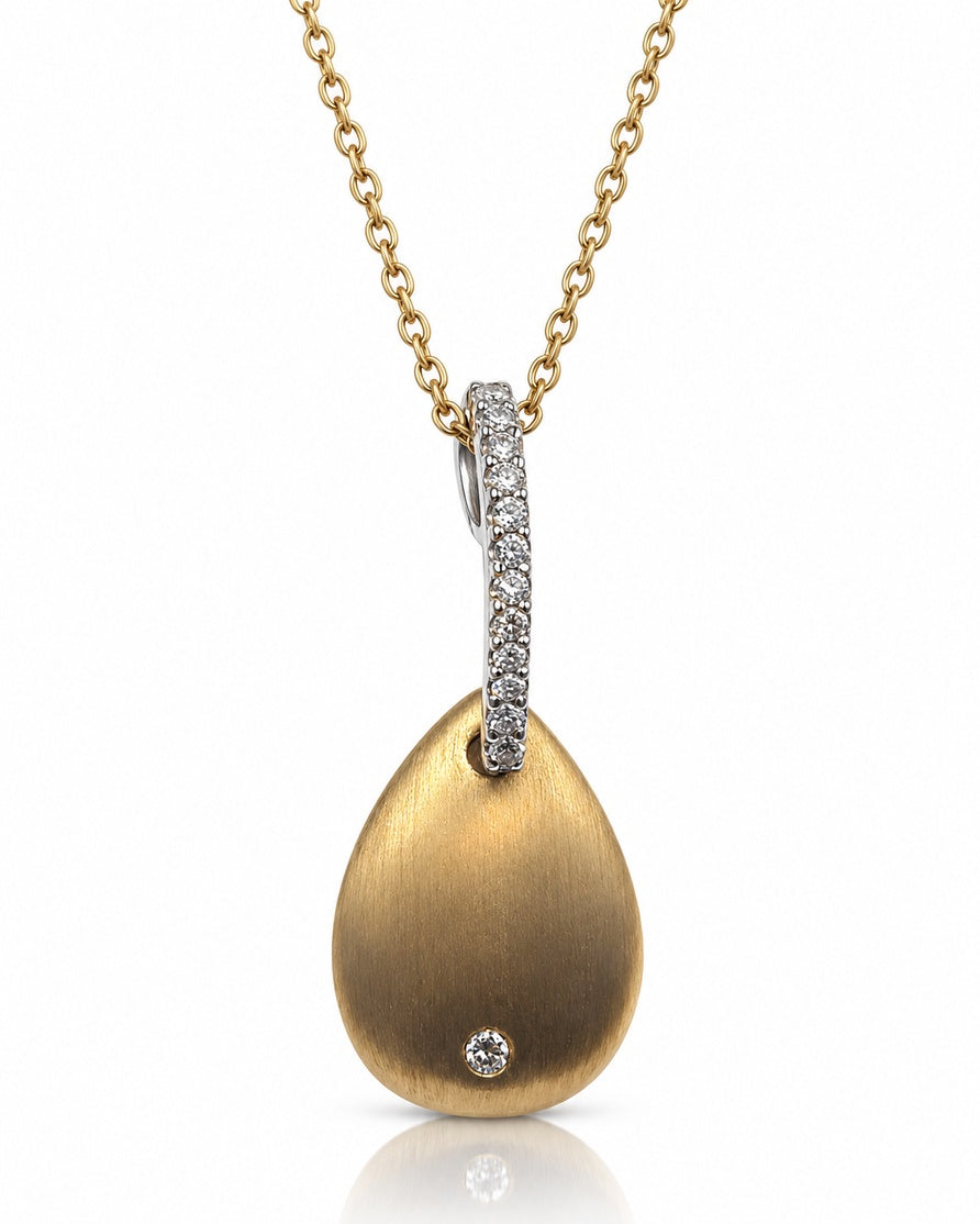 Brushed yellow gold teardrop pendant with bezel-set round diamond and pavé white gold bail on cable chain