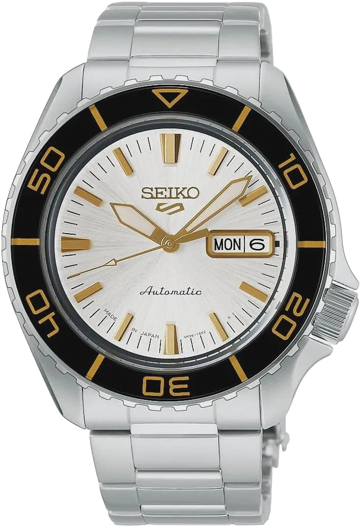 Seiko 5 Sports HDB004K1 automatic watch with silver sunray dial, black unidirectional bezel with gold numerals, and stainless steel three-link bracelet on white background