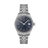 Tissot Ballade Swiss Quartz watch with sunburst blue dial, fluted stainless steel bezel, and three-link stainless steel bracelet on white background