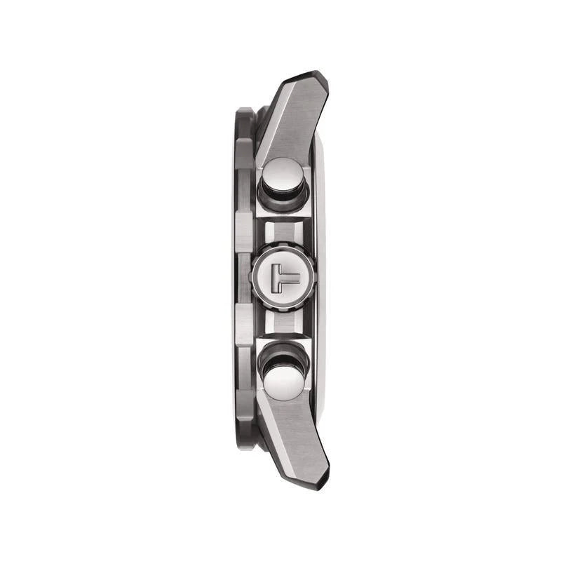 Black dial with red accents and chronograph subdials close up