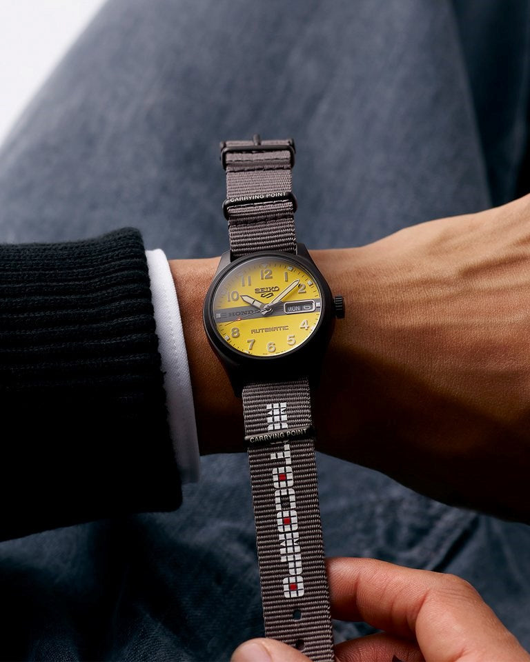 Yellow dial with grey centre band and HONDA logo close-up