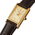 Side profile of 6.1mm thick gold-tone steel case and leather strap