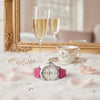 Cassims&Co. pre-owned Breitling Colt Lady watch with white dial and pink leather strap on a white faux fur background.