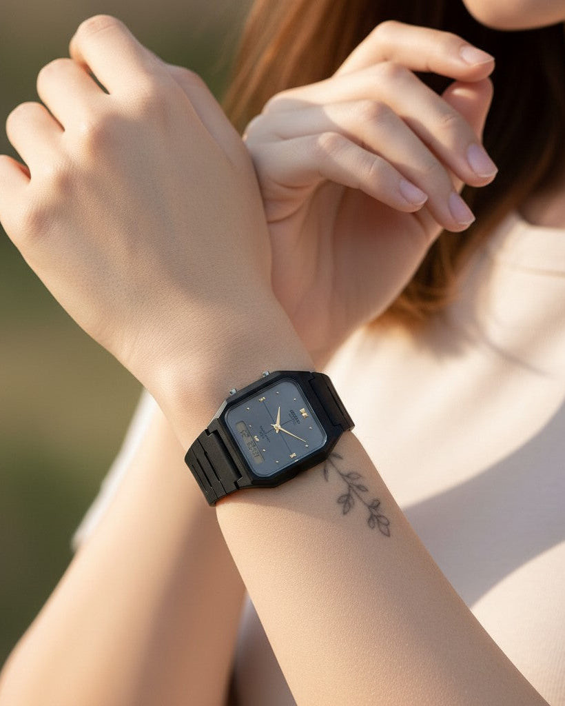 Cassims&Co. Casio ana-digi watch with grey dial and black resin strap worn on a woman's wrist