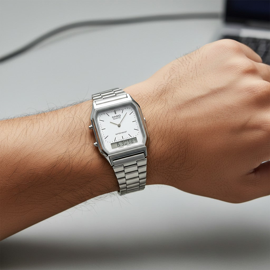 Cassims&Co. Casio AQ-230A ana-digi watch with a white dial and stainless steel bracelet worn on a wrist.