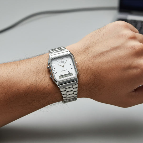 Cassims&Co. Casio AQ-230A ana-digi watch with a white dial and stainless steel bracelet worn on a wrist.