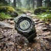 Cassims&Co. Casio G-Shock GD-010-3 green resin digital watch with 10-year battery in a rainy forest setting.