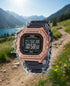 Cassims&Co. Casio Illuminator digital watch with rose gold case and black resin strap splashing in mountain landscape
