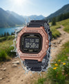 Cassims&Co. Casio Illuminator digital watch with rose gold case and black resin strap splashing in mountain landscape