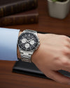 Cassims&Co. Casio stainless steel watch with black multifunction dial and three-link bracelet on a man's wrist