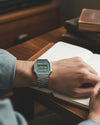 Cassims&Co. Casio vintage digital watch with a green dial and stainless steel bracelet worn on a man's wrist.