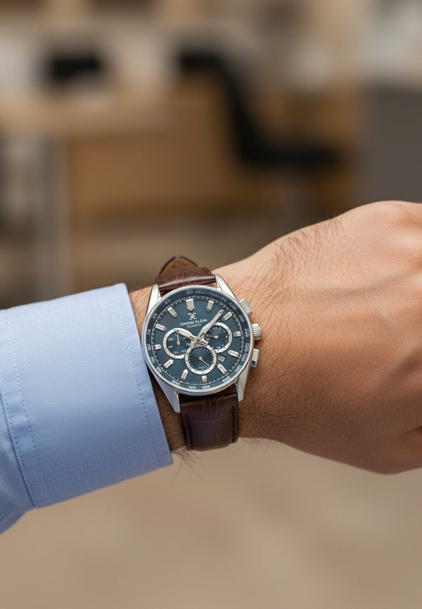 Cassims&Co. Daniel Klein chronograph watch with blue sunburst dial and brown crocodile-embossed leather strap on wrist