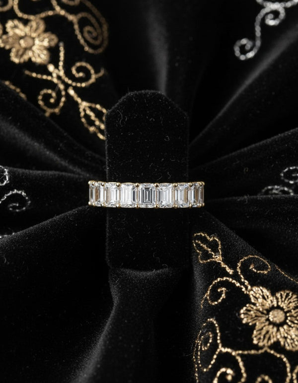 Cassims&Co. 9ct yellow gold eternity band featuring 2.03ct emerald cut lab grown diamonds in a four-prong setting.