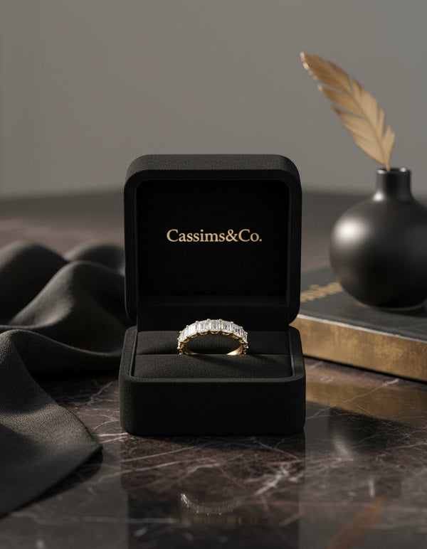 Cassims&Co. 9ct yellow gold eternity band featuring 2.03ct emerald cut lab grown diamonds in a black velvet ring box.