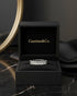 Cassims&Co. 9ct white gold eternity ring featuring nine emerald-cut lab grown diamonds in a black presentation box.