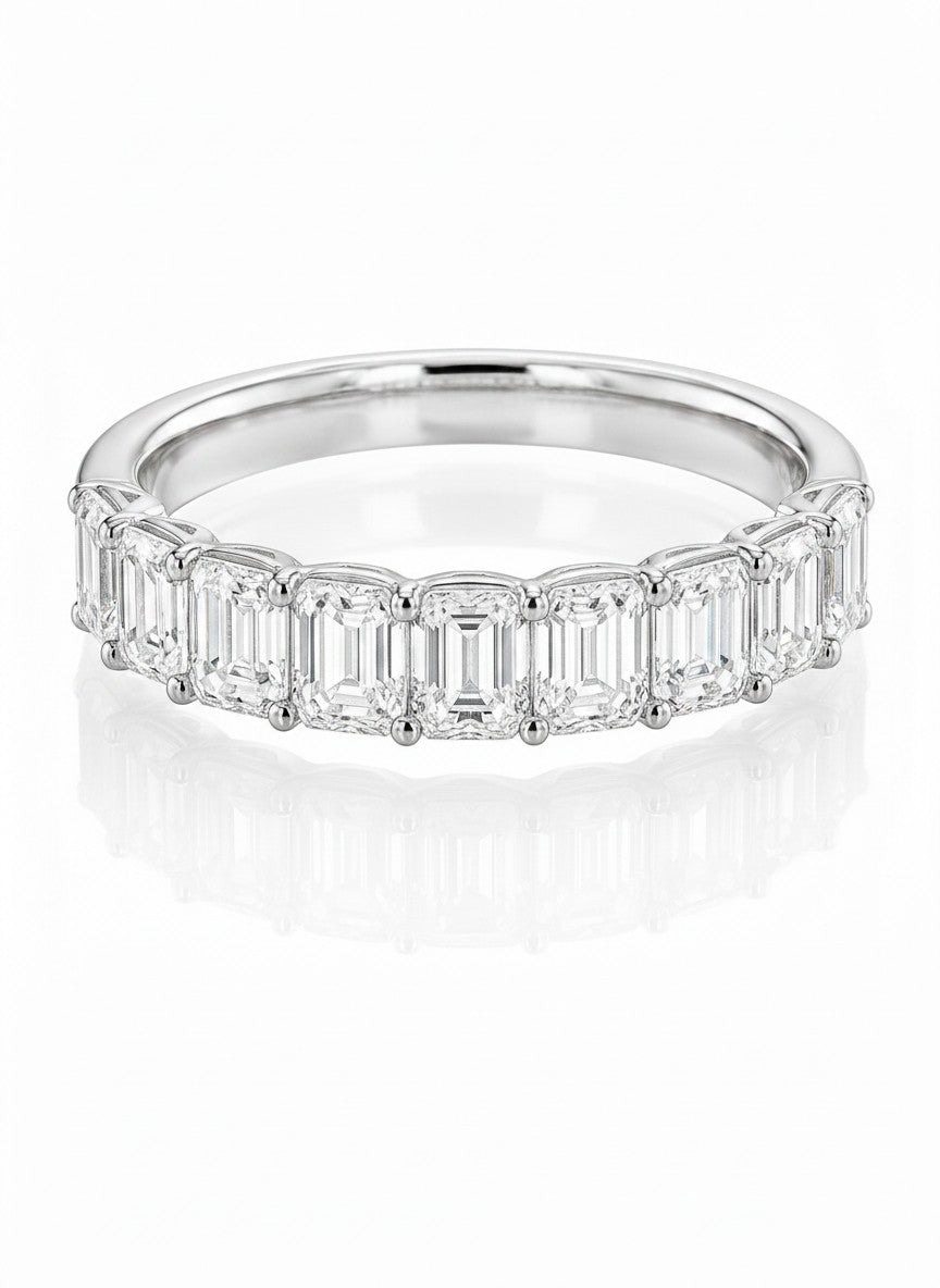Cassims&Co. 9ct white gold eternity ring featuring nine emerald-cut lab grown diamonds in a prong setting.