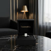 Cassims&Co. 1.00ct emerald-cut lab grown diamond solitaire engagement ring in 9ct white gold inside a black gift box.